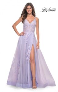 This elegant lavender two tone tulle A-line prom dress with stunning lace applique features lace in two colors that really stand out on the tulle fabric. A V-neckline, adjustable spaghetti straps, high slide slit , illusion waist with boning detail and back zipper closure complete the design of this amazing flowing dress.