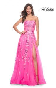 Sophistication awaits you with this neon pink sequined floral embellished A-line prom dress. This exquisite dress features a fitted strapless bodice with exposed boning, full skirt with high slit and back zipper closure.