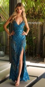 This elegant and stylish peacock prom dress features sequined beads with fringed accents, a deep v-neck. spaghetti straps, a high side slit with lace up back and sweeping train