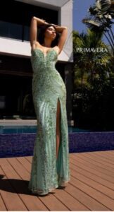 Strapless and sequined is this elegant mint colored prom dress. It features a fitted body, high side slit, a mid-open back and a train to follow you into your dream event.