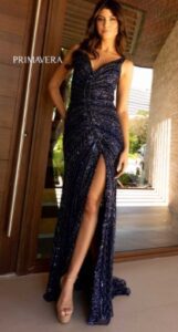 Fitted and sequin embellished, is this midnight colored prom dress features a high side slit, open low back and a subtle elegance from every angle.