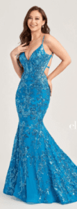 This distinctive cerulean blue mermaid style prom dress features sequin tulle fabric with a v-neck, spaghetti straps and a lace up back.