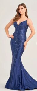 This distinctive navy blue mermaid style dress features jersey spandex for comfort, stone accents, a plunging sweetheart neckline with a lace up back.
