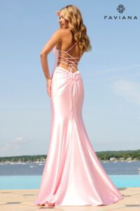 So elegant, this light pink dress is all about the back! This beautiful stretch satin gown with an elegant, clean silhouette from the front, and a strappy lace up back and knot detail on the lower back for a gorgeous and elongated look.