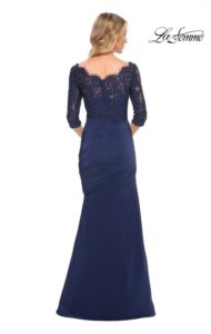 Captivating and classy, this navy blue colored jersey Mother of the Bride / Groom dress features a beautifully beaded lace bodice and a skirt with elegant asymmetrical gathering. A back zipper closure complete the design of this gorgeous dress.