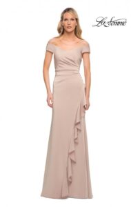 Our chic champagne colored Mother of the Bride / Groom dress features an off the shoulder gown with ruching across the front and ruffle edge on the faux wrap skirt. A back zipper closure complete the design of this stylish dress.