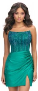 This strapless emerald green jersey dress features a corset bustier embellished with press on stones and left leg slit and zippered back closure