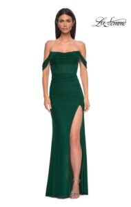 Simple and chic, this emerald net jersey dress features a modified sweetheart neckline and draped off the shoulder straps. The waist features an illusion design with exposed boning. The skirt has ruching and a slit, with back zipper closure. This dress is also available in dark berry and black colors.