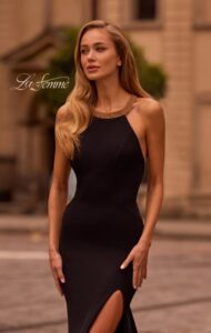 La Femme Prom Dress 32976 This chic black evening dress features a high neckline and low back. The neckline features gold stones. Back zipper closure.