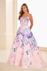 Dress shown in light pink/multi and also available in other colors: dark purple/multi, and royal/multi. This floral ball gown features a sweetheart neckline with corset bodice.