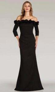 Dress shown in black and is also available in blush, cobalt, and silver. Step into timeless elegance with this off-the-shoulder gown that hugs your curves in all the right places, accentuated with delicate 3D floral accents and a sleek silhouette.